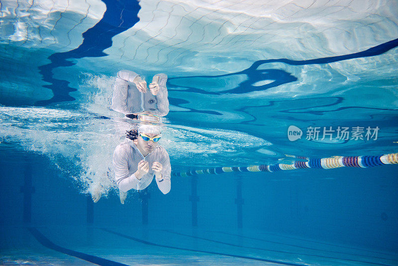 Male swimmer swimming underwater in a pool